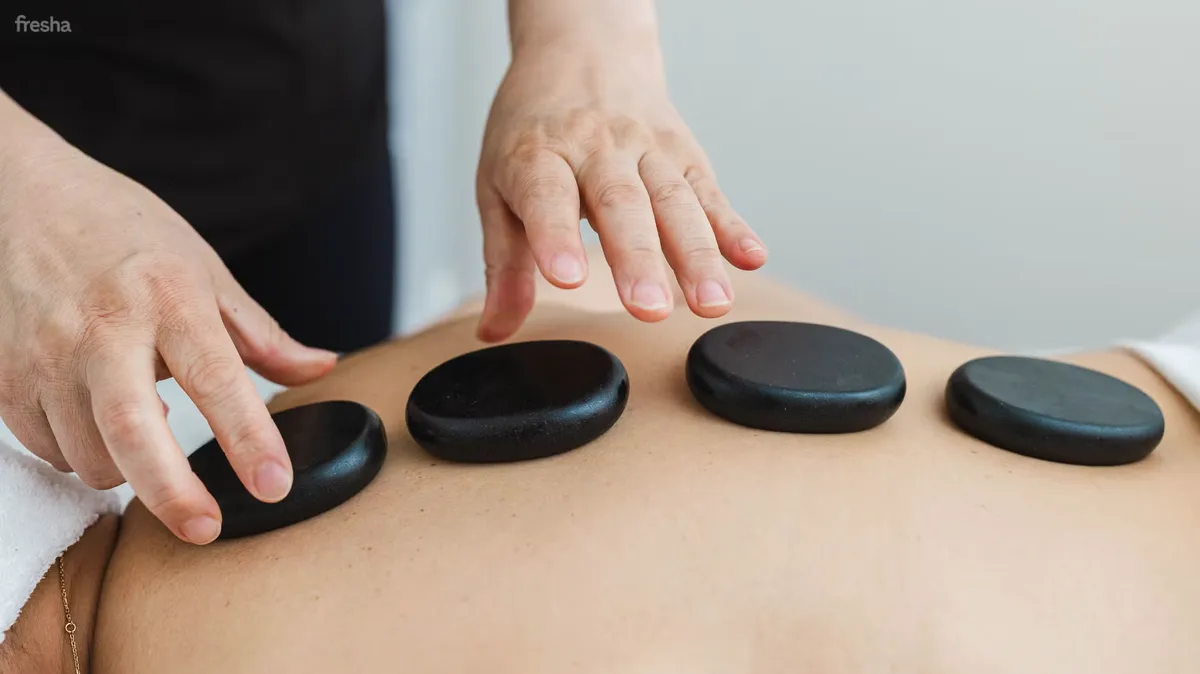 Hot stones resting on a guest's back